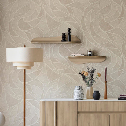 A styled interior scene showing a light wood sideboard or credenza against a beige patterned wallpaper wall, with a floor lamp, chair, rug, and staircase visible in a real room setting.