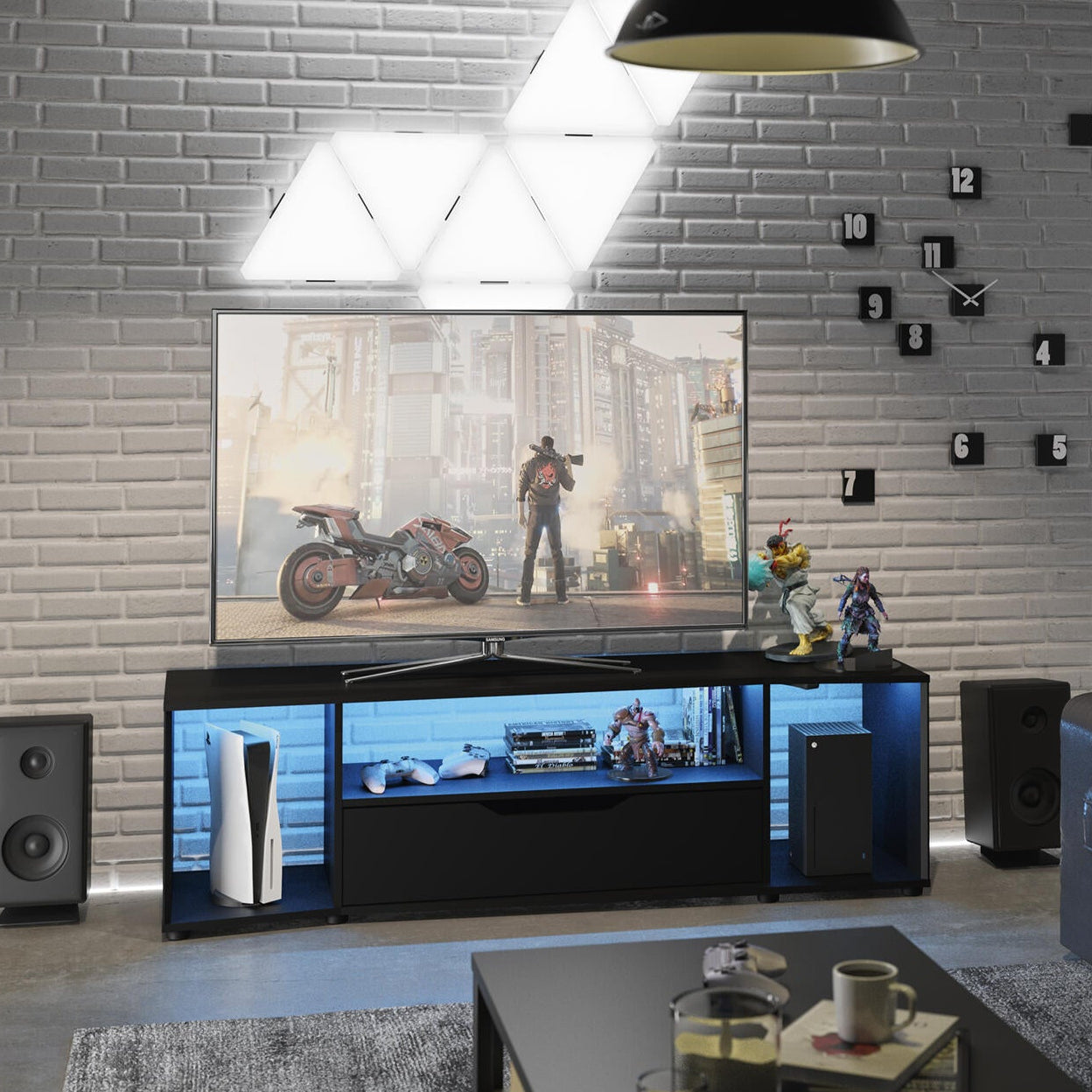 Modern living room with a TV, speakers, and a sofa.