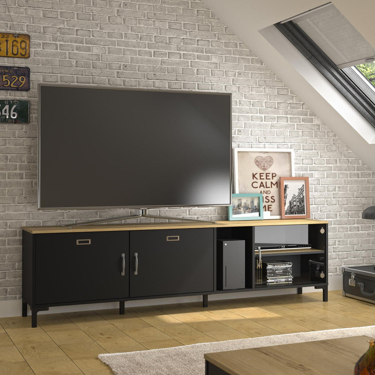 Modern living room with a TV, sofa, and decorative items.